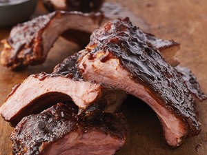 Baby Back Ribs with Barbecue Sauce on Wood Surface