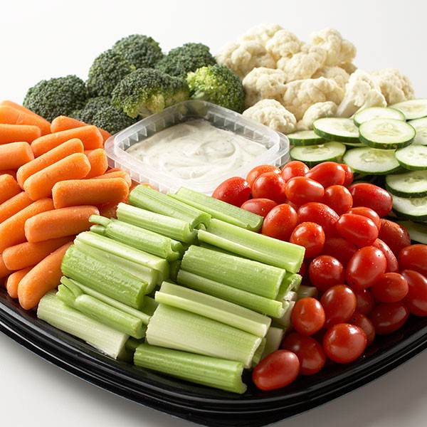 vegetable platter with celery, carrots, cherry tomatoes, cucumbers, broccoli, cauliflower, and dip