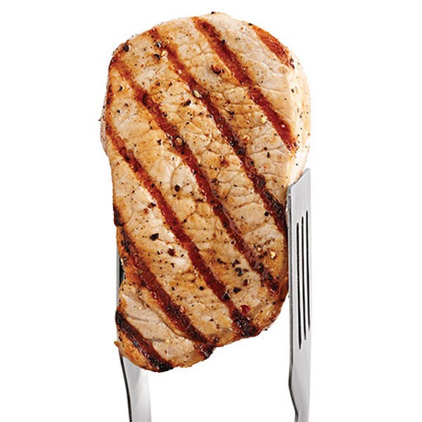 Grilled Pork Chop Held Up by Metal Tongs