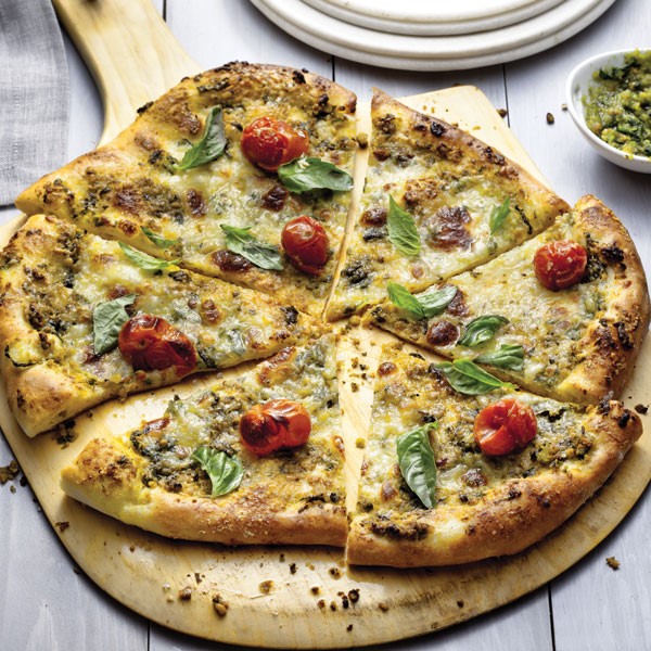 Pizza topped with Pesto, Basil Leaves, and Tomatoes