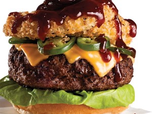 Rodeo Burger with Melted Yellow Cheese, Jalapeno Slices, Onion Rings, and Barbecue Sauce