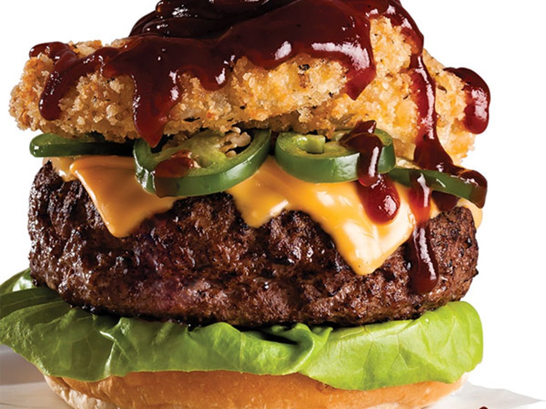 Rodeo Burger with Melted Yellow Cheese, Jalapeno Slices, Onion Rings, and Barbecue Sauce